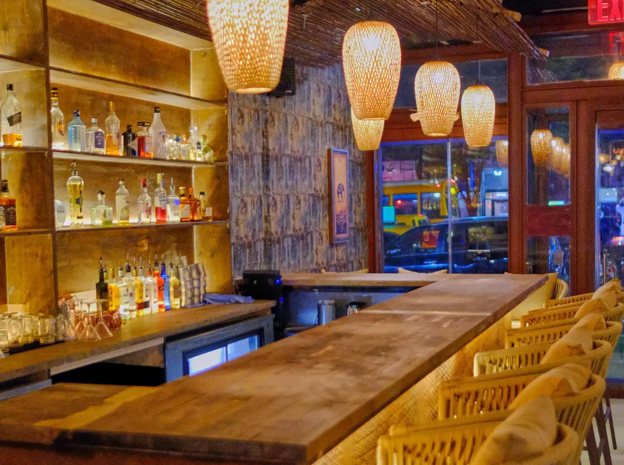 The bar, ready for a pre-theater drink. Cocktail bar with rattan lights at Elephant Ear Thai Hell's Kitchen