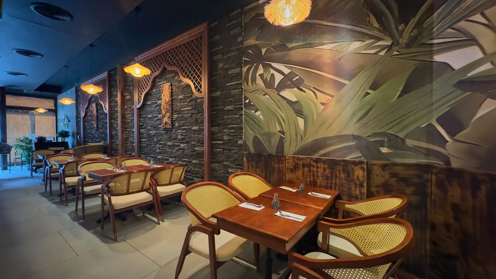 Jungle murals and cozy booths. Jungle mural booth seating at Elephant Ear Thai restaurant