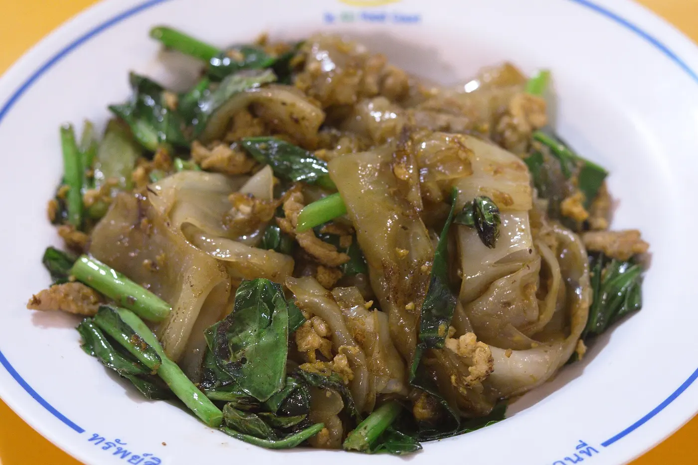 Pad see ew wide rice noodles with Chinese broccoli and dark soy in Bangkok