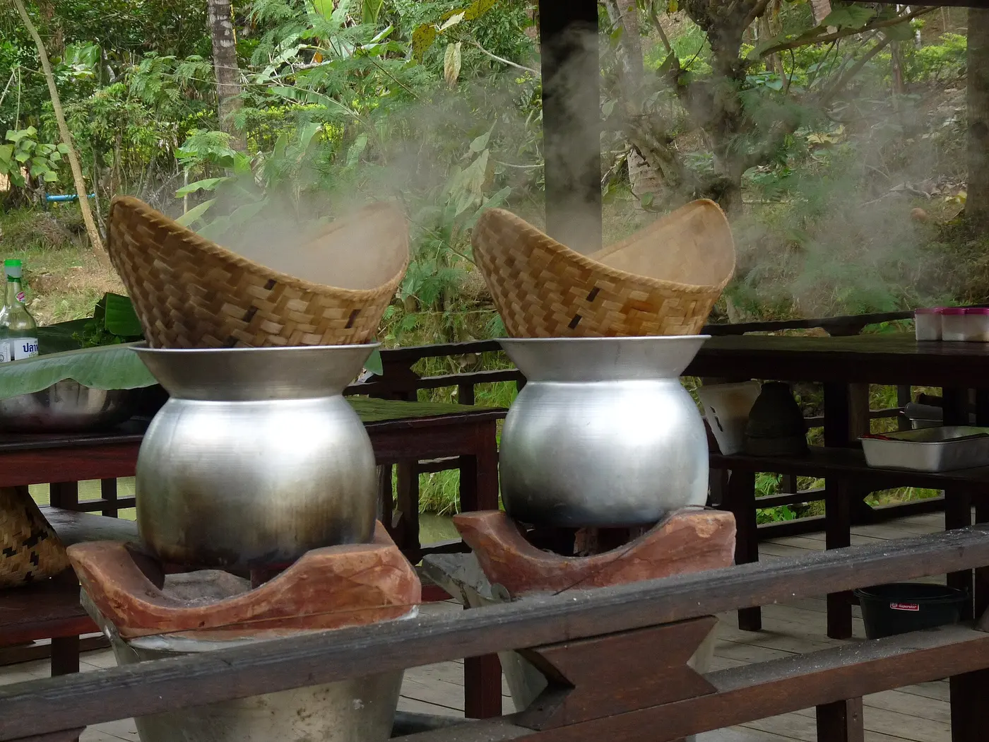 Sticky rice steaming in bamboo baskets in Thailand