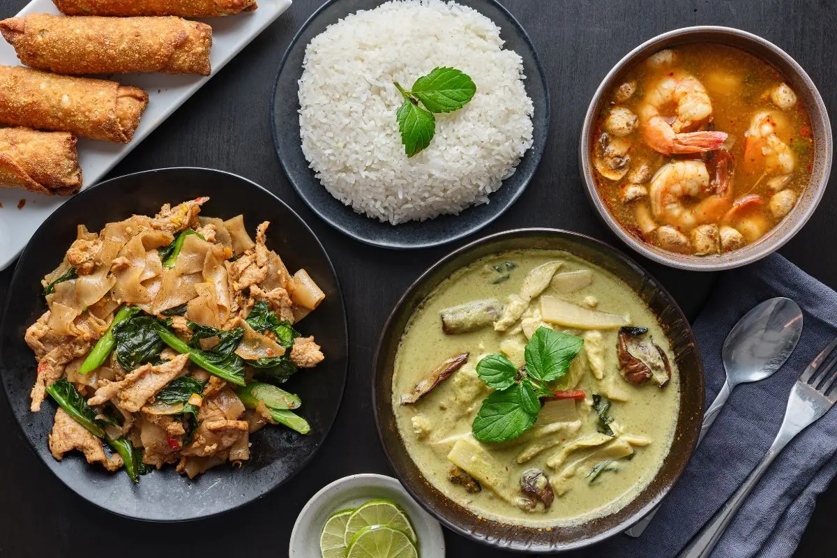 Thai Family-Style Meal Thai family-style spread of shared dishes with rice